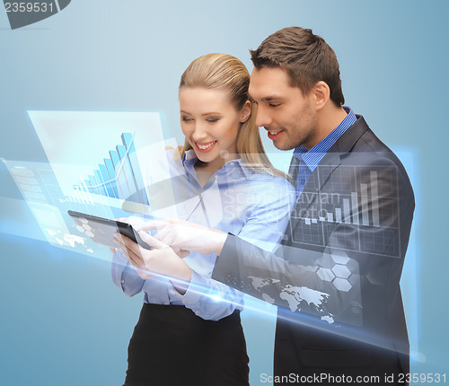 Image of two business people working with virtual screen