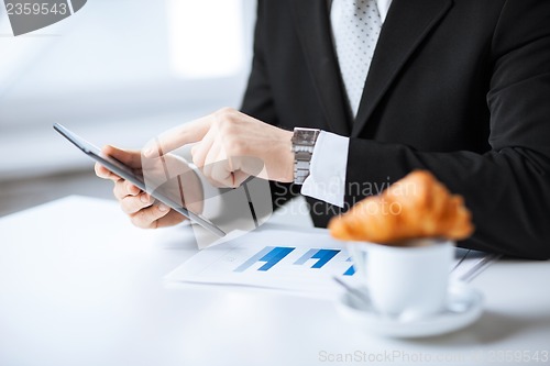 Image of man with tablet pc and cup of coffee