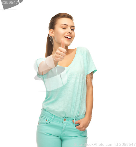 Image of smiling girl in color t-shirt showing thumbs up