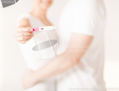 Image of woman and man hands with pregnancy test