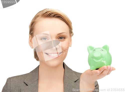 Image of lovely woman with small piggy bank