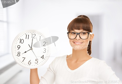 Image of businesswoman with wall clock