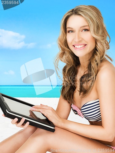Image of woman in bikini with tablet pc computer
