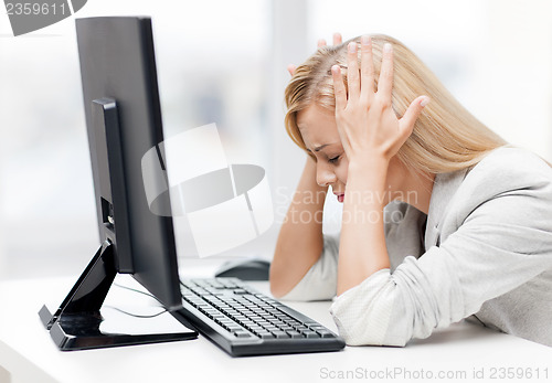 Image of stressed woman with computer