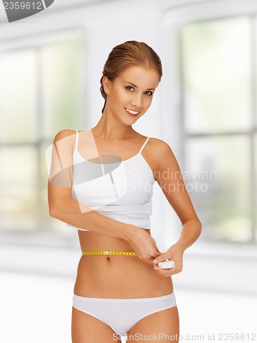 Image of woman measuring her waist