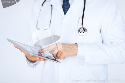 Image of male doctor holding tablet pc