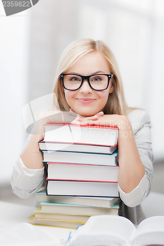 Image of student with stack of books