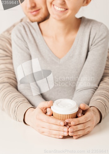 Image of woman and man with take away coffee cup