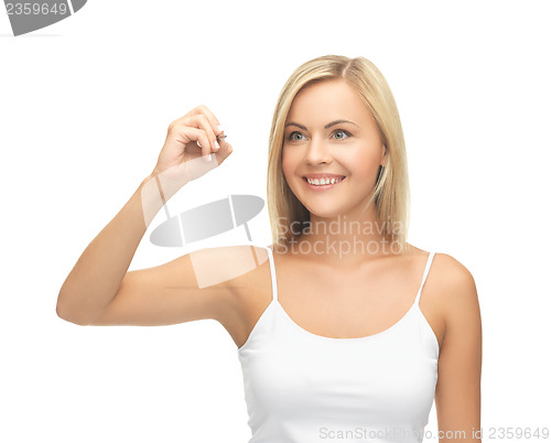 Image of woman in white shirt writing in the air