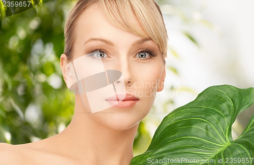 Image of woman with green leaf