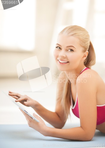 Image of woman lying on the floor with tablet pc