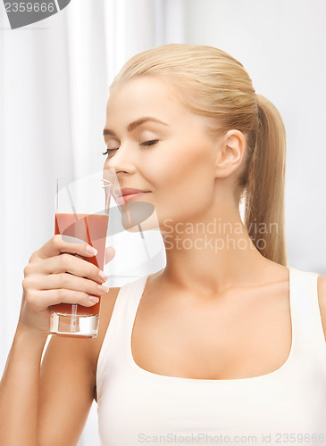 Image of young woman drinking tomato juice
