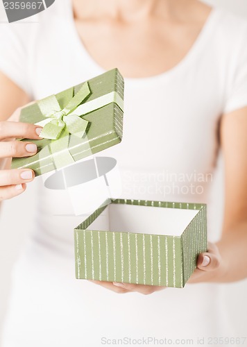 Image of woman hands with gift box