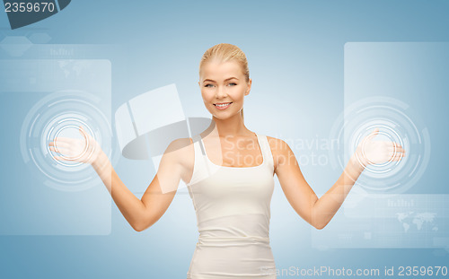 Image of businesswoman touching virtual screen