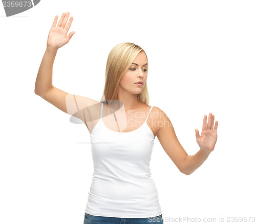Image of woman in white t-shirt pressing imaginary button