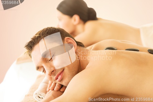 Image of couple in spa with hot stones