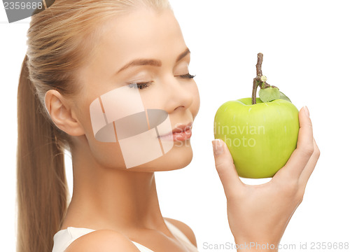 Image of woman smelling apple