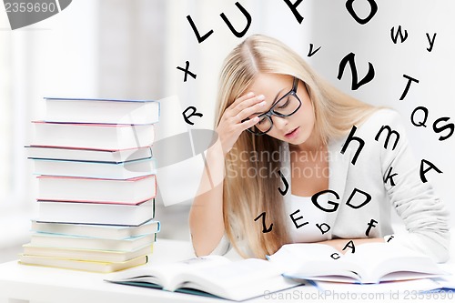 Image of student with books and notes