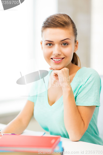 Image of happy smiling student girl with books