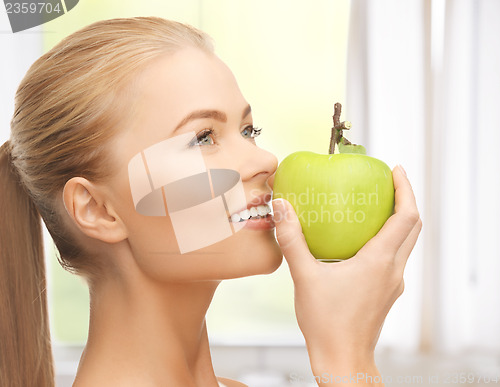 Image of woman smelling apple