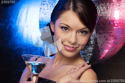 Image of woman with cocktail and disco ball