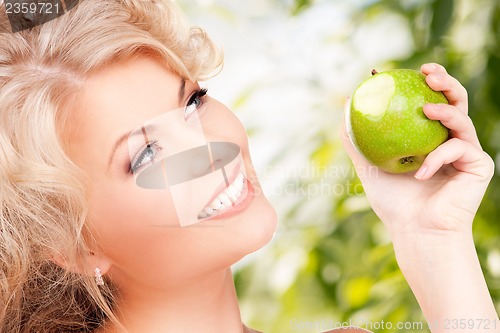 Image of young beautiful woman with green apple