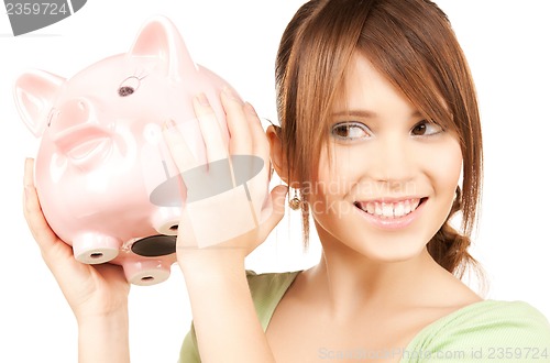 Image of lovely girl with big piggy bank