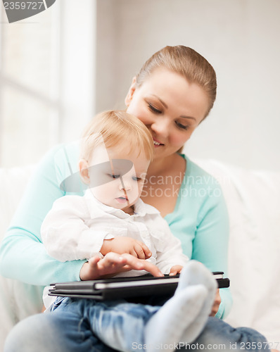 Image of mother and adorable baby with tablet pc
