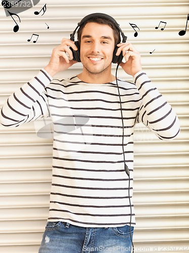 Image of man in casual clothes with headphones