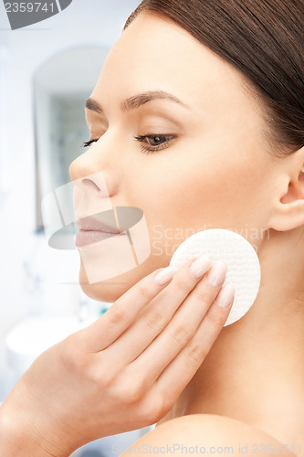 Image of beautiful woman with cotton pad