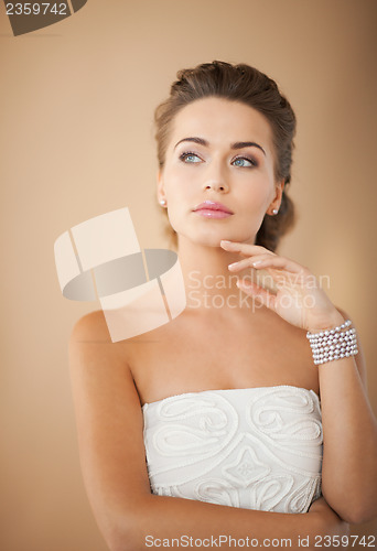 Image of woman with pearl earrings and bracelet