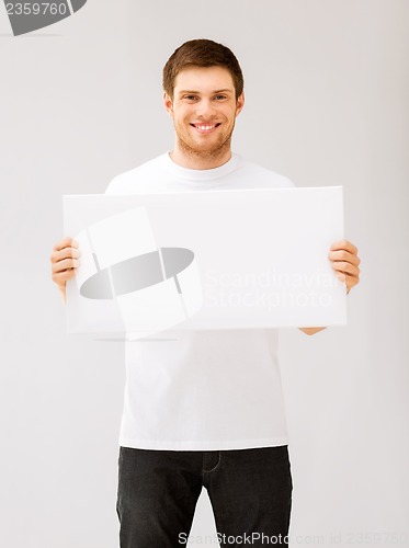 Image of young man holding white blank board