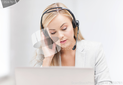 Image of female helpline operator with laptop