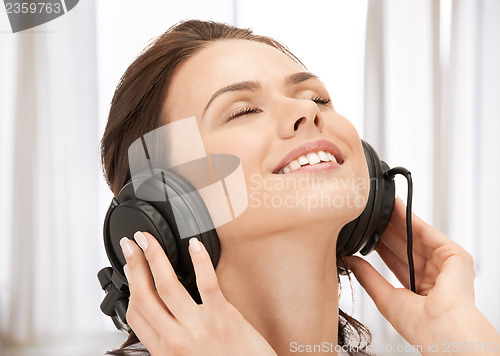 Image of happy teenage girl in big headphones