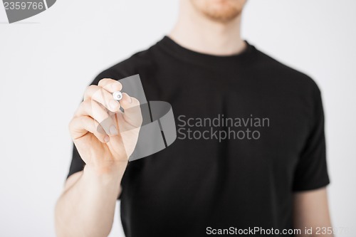 Image of man writing something in the air