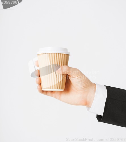 Image of man hand holding take away coffee
