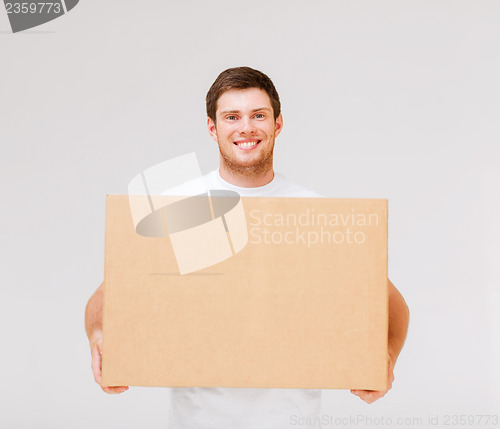 Image of smiling man carrying carton box