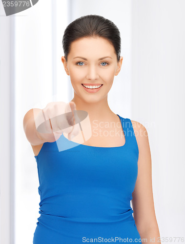 Image of beautiful woman pointing her finger