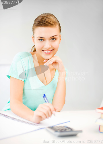 Image of student girl with notebook and calculator