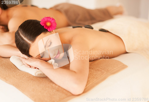 Image of couple in spa with hot stones