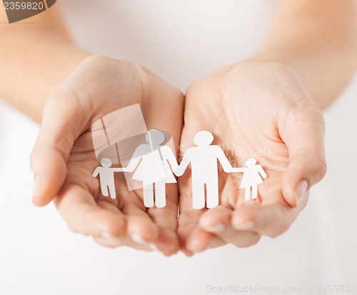 Image of womans hands with paper man family