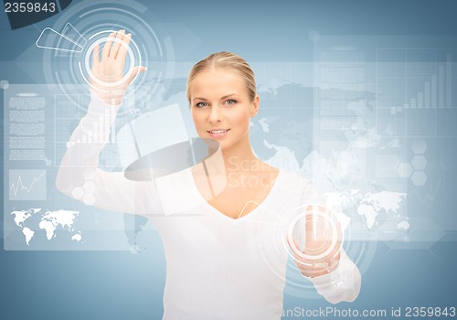 Image of businesswoman touching virtual screen