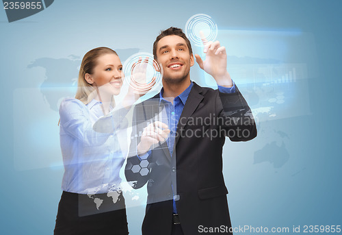 Image of two business people working with virtual screen