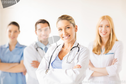 Image of female doctor in front of medical group