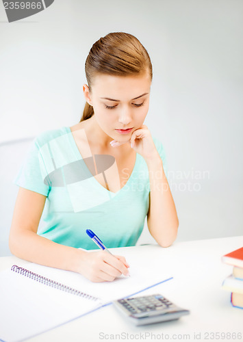 Image of student girl with notebook and calculator