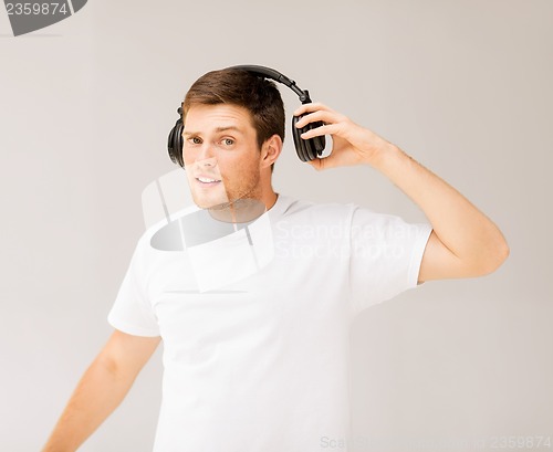 Image of man with headphones listening loud music