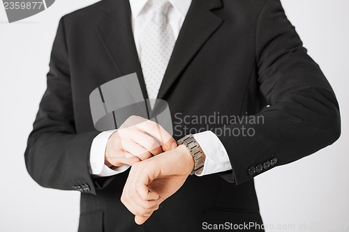 Image of man looking at wristwatch