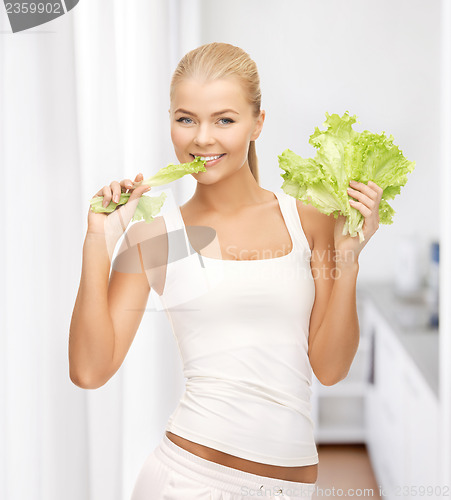 Image of woman biting lettuce