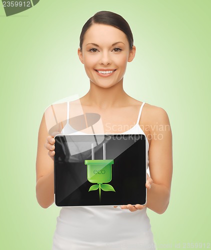 Image of woman holding tablet pc with green electrical plug