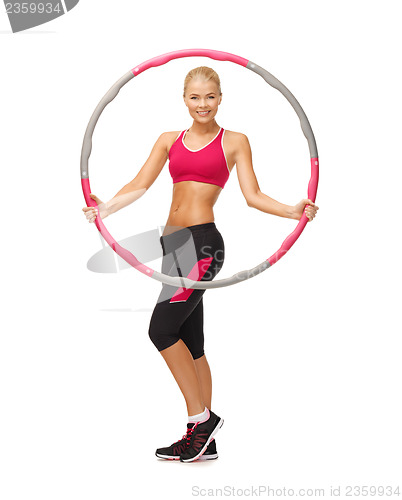 Image of young sporty woman with hula hoop